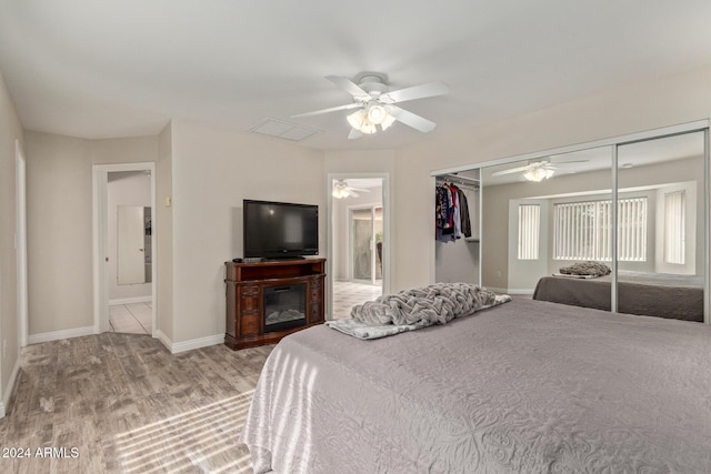 bedroom featuring light hardwood / wood-style floors, a closet, and ceiling fan