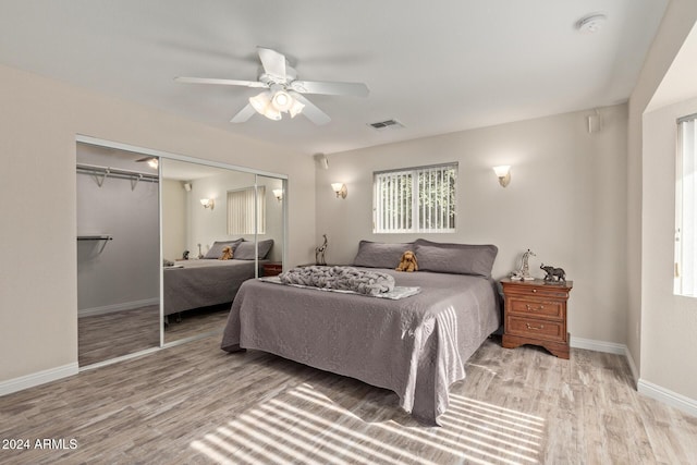 bedroom featuring ceiling fan, light wood-type flooring, and a closet