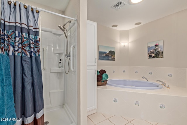 bathroom featuring plus walk in shower and tile patterned flooring