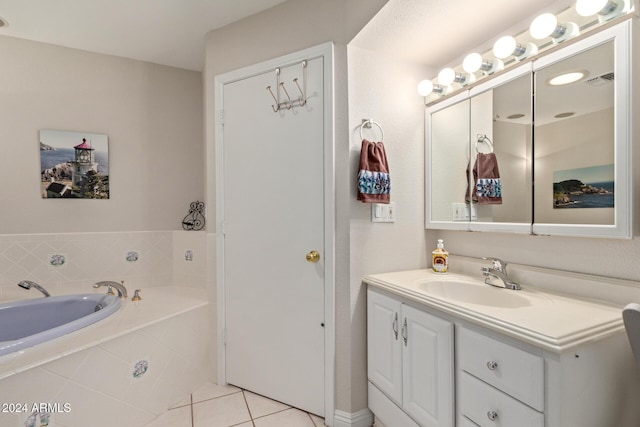 bathroom with tile patterned floors, vanity, and tiled bath