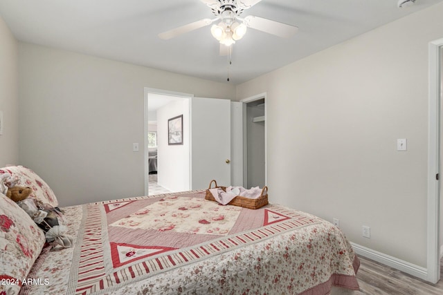 bedroom with light hardwood / wood-style flooring and ceiling fan