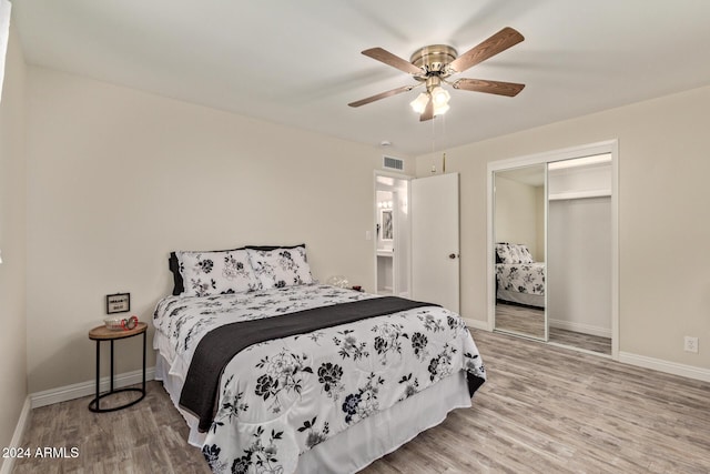 bedroom with ceiling fan, a closet, and wood-type flooring