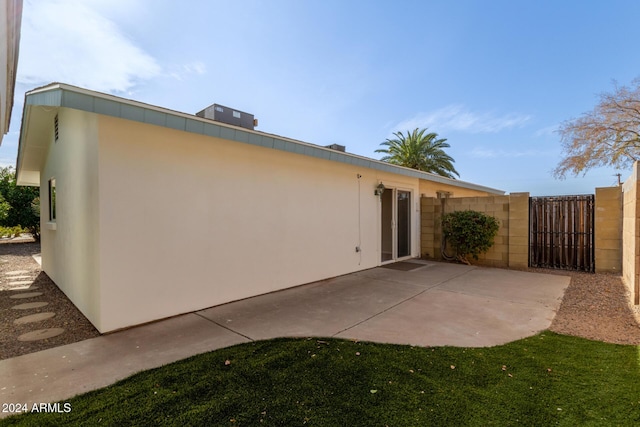 view of home's exterior featuring central air condition unit and a patio