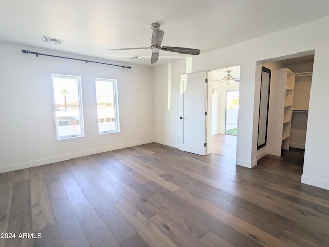 unfurnished room with ceiling fan and wood-type flooring