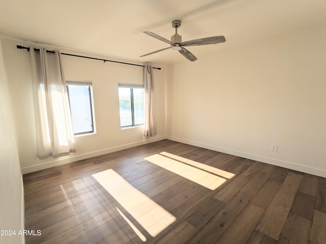 unfurnished room with dark hardwood / wood-style floors and ceiling fan