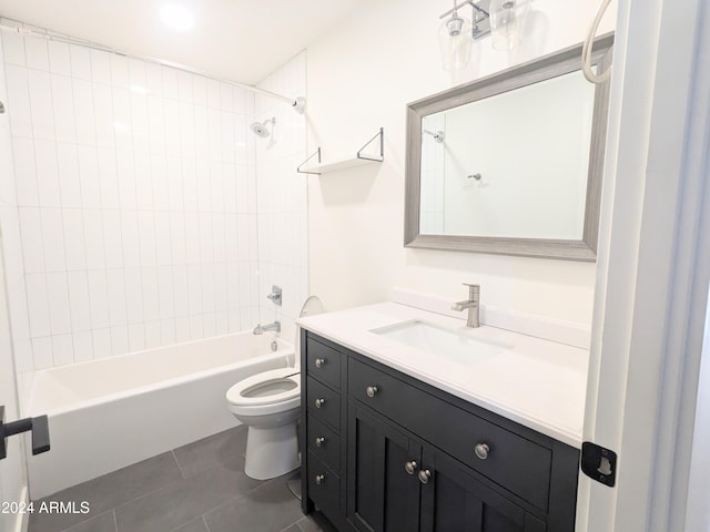 full bathroom with tiled shower / bath, vanity, toilet, and tile patterned floors