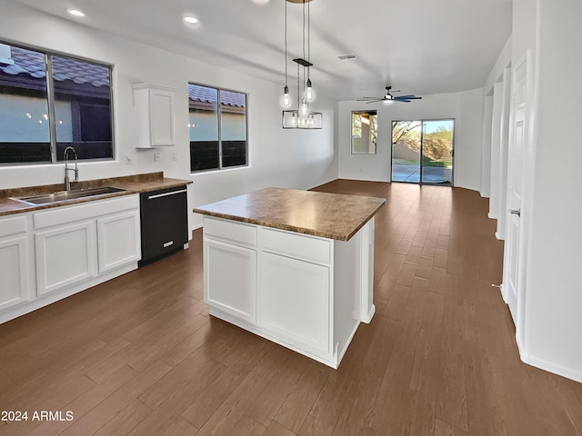 kitchen featuring white cabinets, sink, ceiling fan, black dishwasher, and a kitchen island