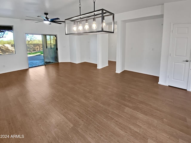 unfurnished dining area with ceiling fan and dark hardwood / wood-style flooring