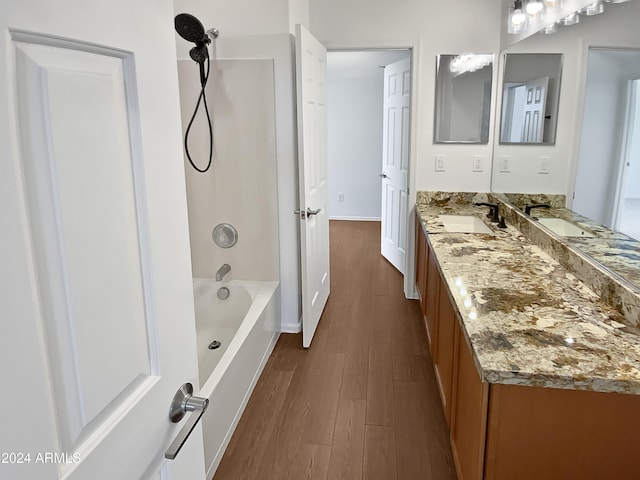 bathroom featuring vanity, wood-type flooring, and bathtub / shower combination