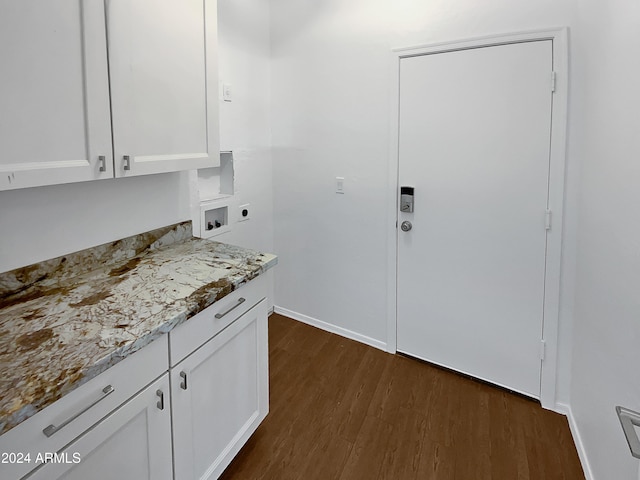 kitchen with white cabinetry, dark hardwood / wood-style flooring, and light stone counters