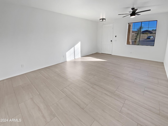 spare room with ceiling fan and light wood-type flooring