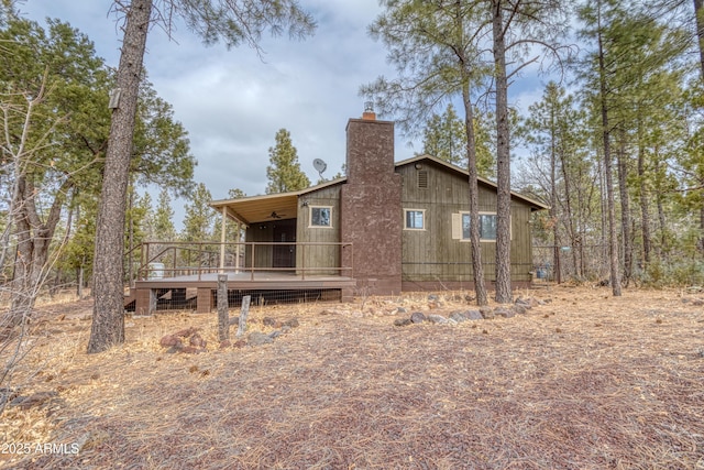 rear view of property featuring a deck