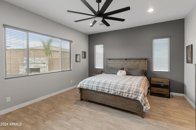 bedroom with ceiling fan and multiple windows