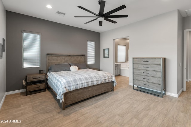 bedroom featuring ceiling fan and ensuite bath