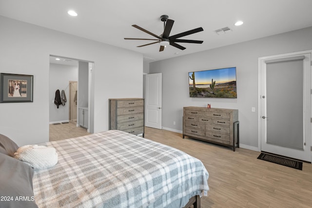 bedroom with ensuite bath, light hardwood / wood-style floors, and ceiling fan