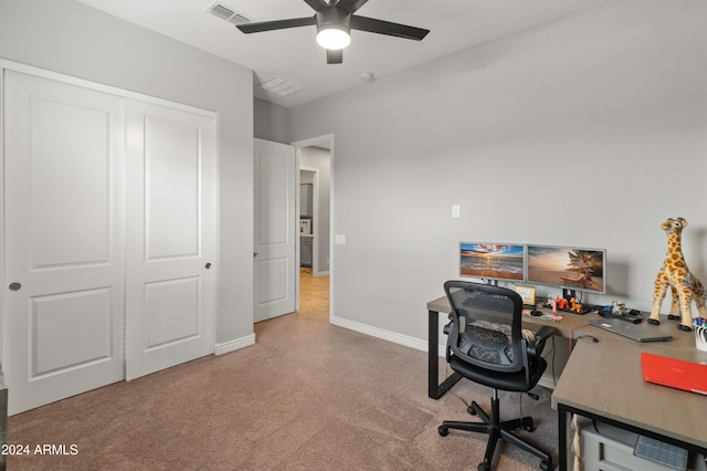 office area featuring light carpet and ceiling fan