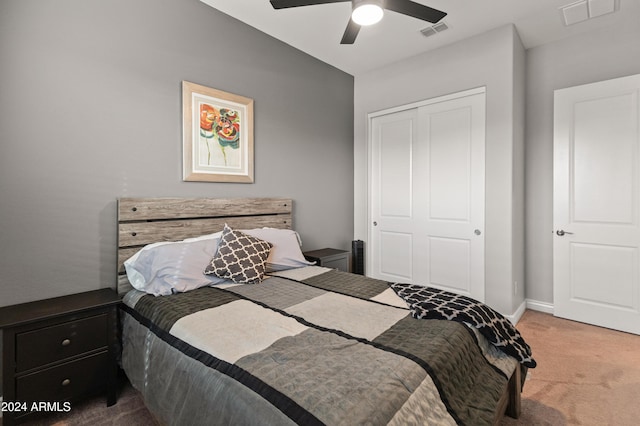 bedroom featuring light carpet, a closet, and ceiling fan