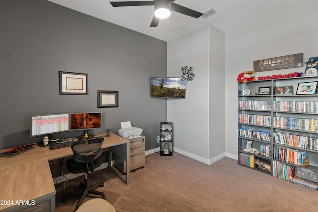 carpeted office space with ceiling fan