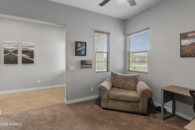 sitting room featuring ceiling fan and carpet