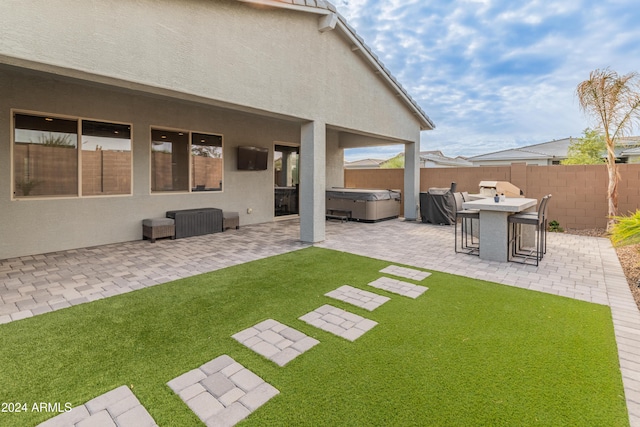 view of yard with a hot tub and a patio