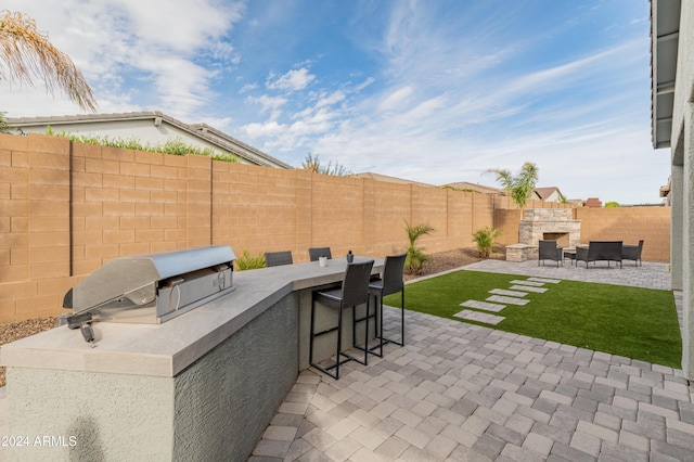 view of patio with a bar and area for grilling