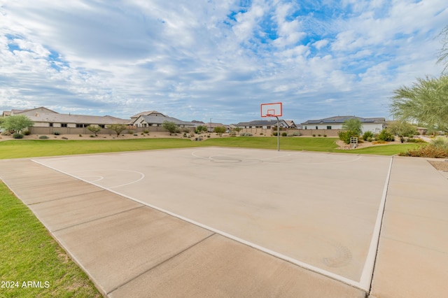 view of basketball court with a yard