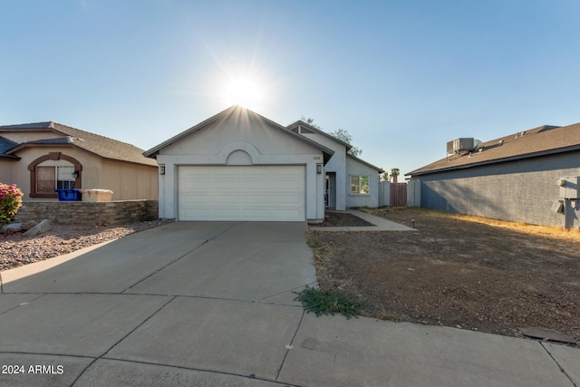7394 N 67th Dr, Glendale, AZ 85303 - single story home with stucco siding, driveway, a garage, and central AC unit