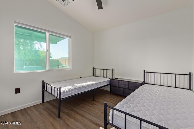 bedroom with ceiling fan, hardwood / wood-style flooring, and lofted ceiling