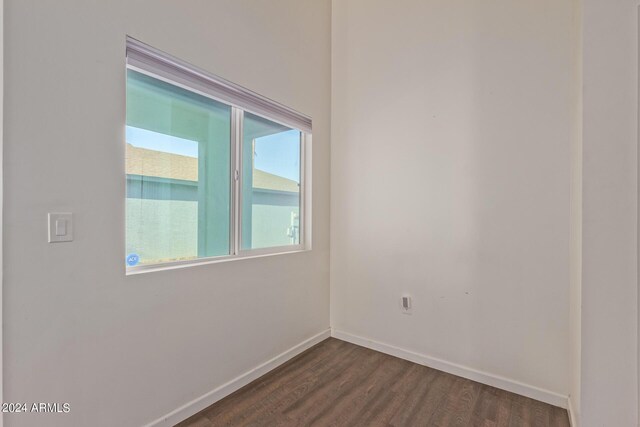 7394 N 67th Dr, Glendale, AZ 85303 - spare room with baseboards and dark wood-style flooring