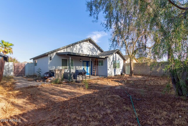 7394 N 67th Dr, Glendale, AZ 85303 - back of house with a fenced backyard, a gate, and stucco siding