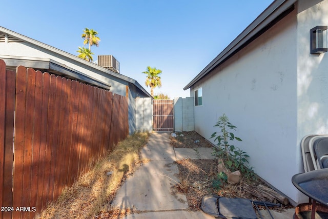 7394 N 67th Dr, Glendale, AZ 85303 - view of home's exterior featuring a gate, stucco siding, cooling unit, and fence