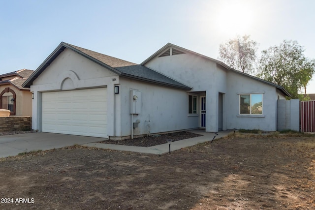 7394 N 67th Dr, Glendale, AZ 85303 - view of front of home featuring a garage, stucco siding, concrete driveway, and fence
