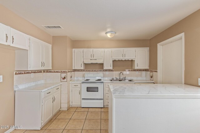 12547 W Warner St, Avondale, AZ 85323 - kitchen featuring white range with electric stovetop, under cabinet range hood, a sink, and white cabinets