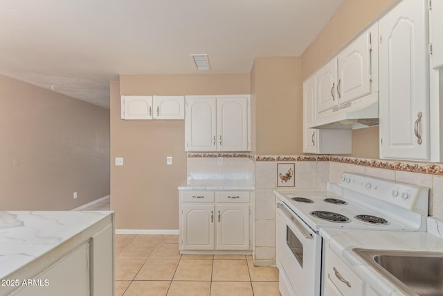 12547 W Warner St, Avondale, AZ 85323 - kitchen with under cabinet range hood, white electric stove, white cabinetry, light tile patterned flooring, and light stone countertops