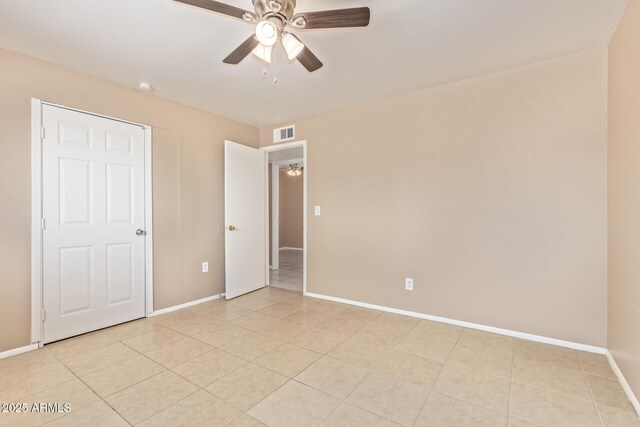 12547 W Warner St, Avondale, AZ 85323 - unfurnished bedroom with baseboards, light tile patterned floors, and ceiling fan
