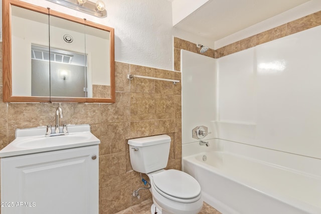 12547 W Warner St, Avondale, AZ 85323 - bathroom with tile walls, washtub / shower combination, toilet, and vanity
