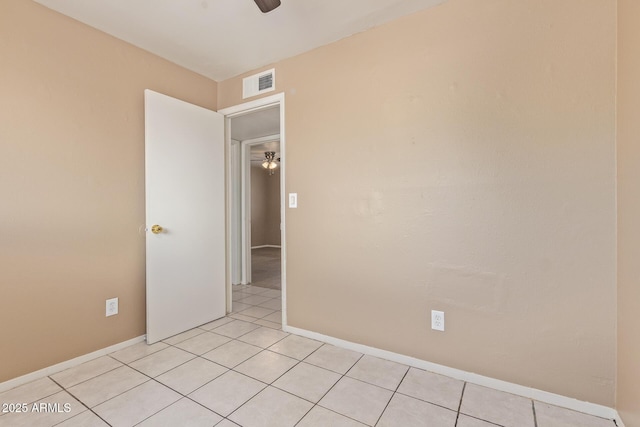 12547 W Warner St, Avondale, AZ 85323 - empty room with ceiling fan, light tile patterned floors, and baseboards