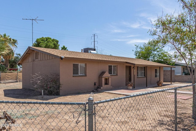 12547 W Warner St, Avondale, AZ 85323 - view of front of house featuring a fenced backyard, brick siding, and board and batten siding