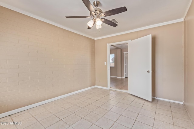 12547 W Warner St, Avondale, AZ 85323 - spare room with a ceiling fan, brick wall, crown molding, light tile patterned flooring, and baseboards