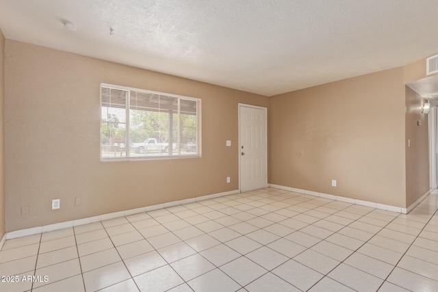 12547 W Warner St, Avondale, AZ 85323 - unfurnished room with baseboards, a textured ceiling, and light tile patterned floors