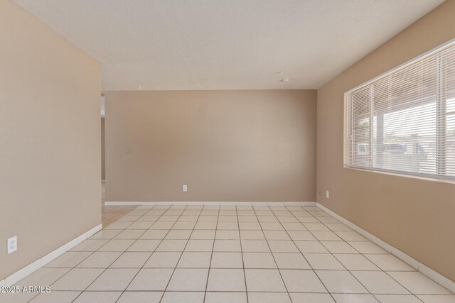 12547 W Warner St, Avondale, AZ 85323 - spare room with baseboards and light tile patterned floors