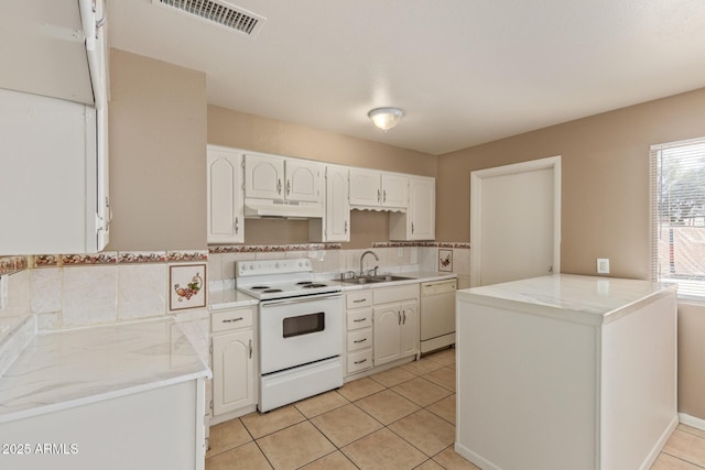 12547 W Warner St, Avondale, AZ 85323 - kitchen with white appliances, under cabinet range hood, a sink, white cabinetry, and light tile patterned floors