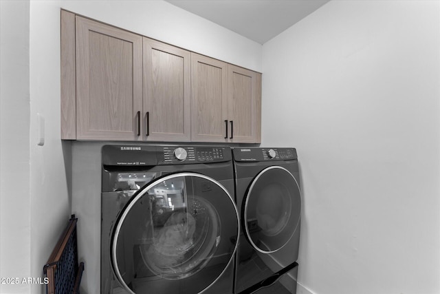 laundry room featuring cabinets, separate washer and dryer, and radiator