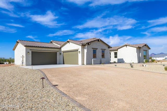 mediterranean / spanish-style house with a garage