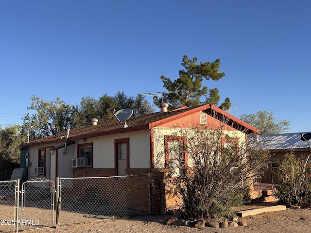 1025 N Sartillion Ave, Ajo, AZ 85321 - view of front of property with a gate, cooling unit, and brick siding
