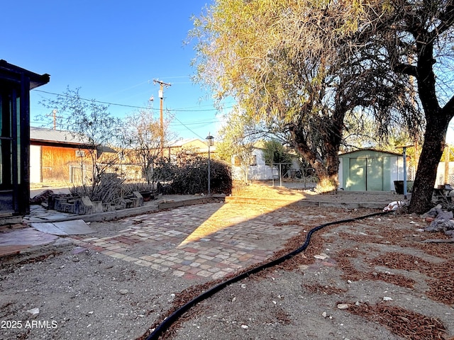 1025 N Sartillion Ave, Ajo, AZ 85321 - view of yard with a storage shed and a patio area
