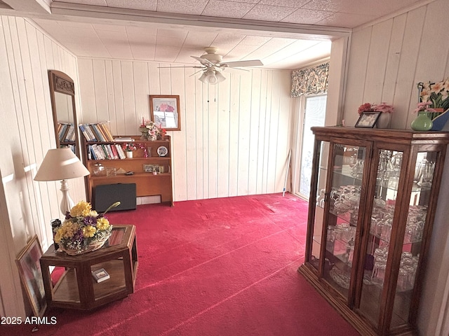 1025 N Sartillion Ave, Ajo, AZ 85321 - sitting room with a ceiling fan, carpet floors, and wood walls