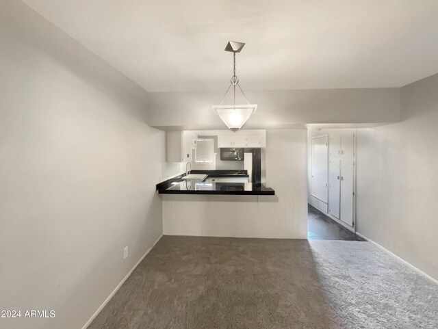 kitchen featuring dark tile patterned floors, white cabinetry, sink, and black appliances