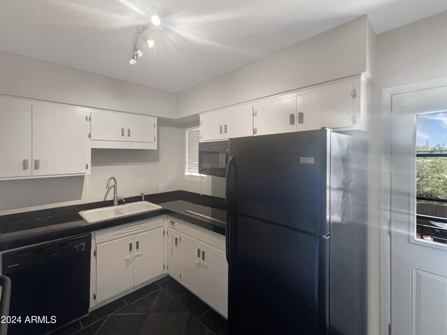 kitchen featuring white cabinets and black appliances