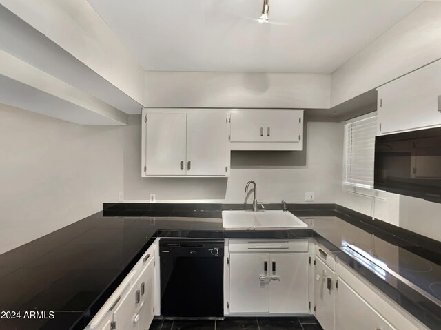 kitchen with black dishwasher, sink, carpet, and white cabinets